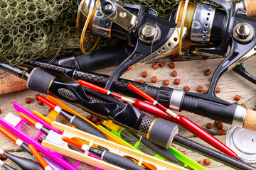 fishing tackle on a wooden table. toned image 