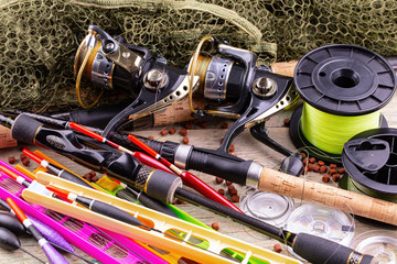 fishing tackle on a wooden table. toned image 