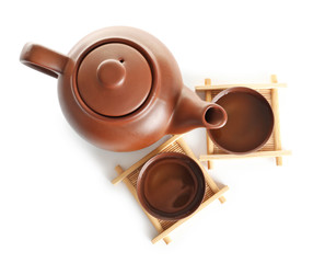Cups and teapot of freshly brewed oolong on white background