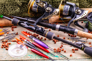 fishing tackle on a wooden table. toned image 