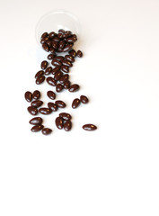 Food image close up candy, chocolate milk, extra dark almond nuts. Love Texture on white grey table top view background on the cup plate