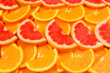 Slices of oranges and a grapefruits as a background.