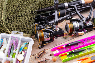 fishing tackle on a wooden table. toned image 