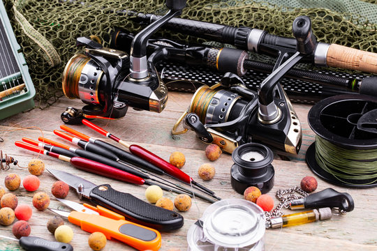 fishing tackle on a wooden table. toned image 