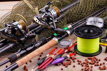 fishing tackle on a wooden table. toned image 