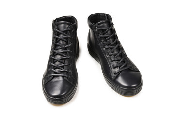 Men's black leather shoes and a black camera on a isolated on white background. Copy space.