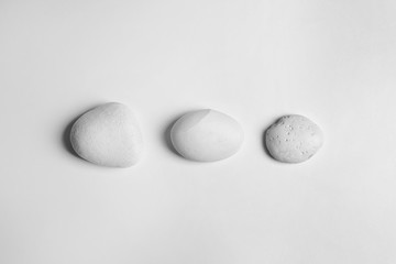 Zen stones on white background, top view
