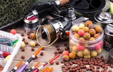 Fototapeta na wymiar fishing tackle on a wooden table. toned image 