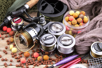 fishing tackle on a wooden table. toned image 