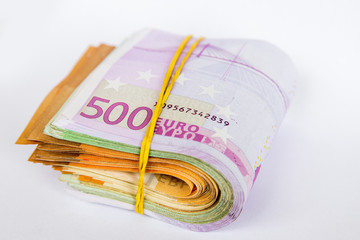 Pile of Euro banknotes isolated on a white background