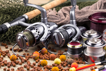 fishing tackle on a wooden table. toned image 