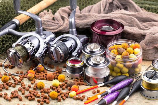 fishing tackle on a wooden table. toned image 