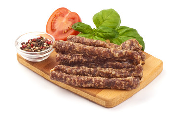 Dry wild meat sticks. Jerky sausages close-up, isolated on white background