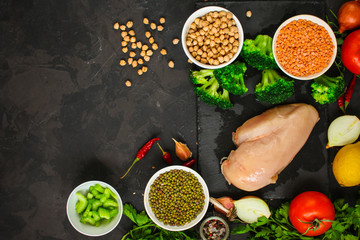 raw chicken meat, vegetables and legumes (lentils, vasol, chickpeas, and more) and a set of ingredients, healthy food - superfood. copy space. food background. top
