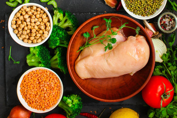 raw chicken meat, vegetables and legumes (lentils, vasol, chickpeas, and more) and a set of ingredients, healthy food - superfood. copy space. food background. top