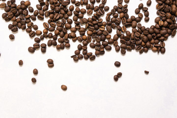 Roasted coffee beans in bulk on a light blue background. dark cofee roasted grain flavor aroma cafe, natural coffe shop background, top view from above, copy space