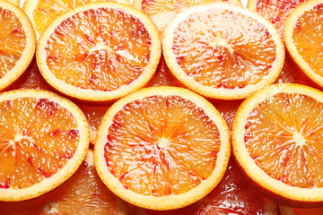 Juicy blood orange slices as background. Citrus fruit