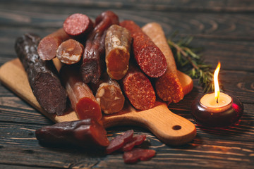 Different types of sausages and meat products on a wooden Board