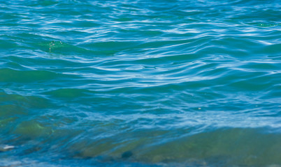 sea landscape is a pebbly beach with waves in white foam