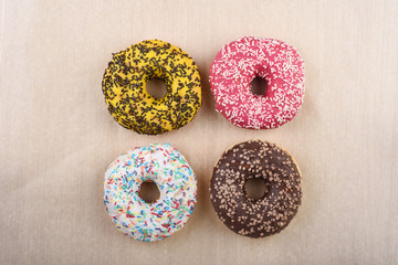 Sprinkled confetti with baked donuts with different icing. Wrapping paper