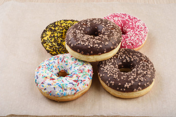 Sprinkled confetti with baked donuts with different icing.