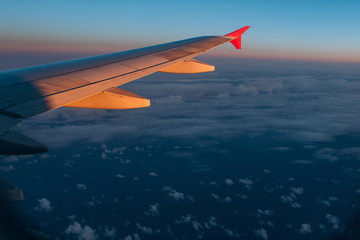 Obraz premium The wing of an airplane in a blue sky.