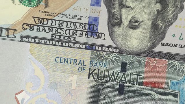 Kuwait dinar against US dollar bill rotating. Kuwait and USA trade. 4K stock video footage