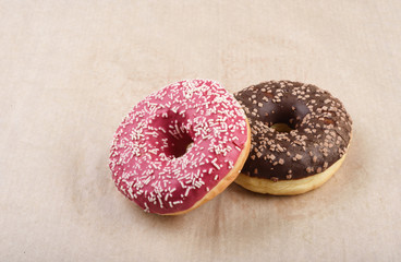 Sprinkled confetti with baked donuts with chocolate and strawberry icing