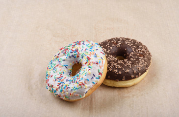 Sprinkled confetti with baked donuts with chocolate and vanilla icing