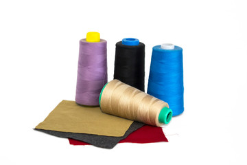 Thread spools fabric on a white background.