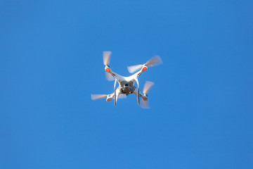 Flying drone with blue sky background, technology