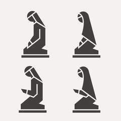 Traditionally clothed Muslim Arab man and woman making a supplication (Salah) versions in different poses