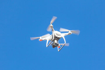 Flying drone with blue sky background, technology
