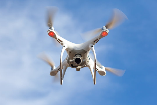 Flying drone with blue sky background, technology