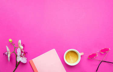 Flowers,  cup of coffee and sunglasses on pink desk background, copy space