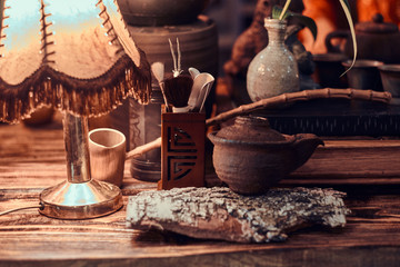 Ancient Chinese Medicine. Close-up view of a wooden table with various accessories 