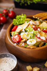 Caesar salad with cherry tomatoes and quail eggs