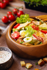 Caesar salad with cherry tomatoes and quail eggs