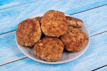 cutlets on a grey plate, on a blue wooden background