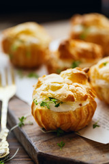 Spicy profiteroles with cream cheese decorated with cress salad
