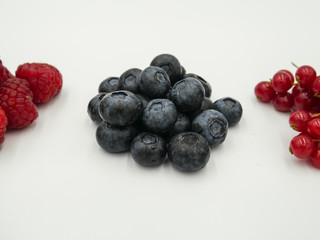 Blueberries pile near other fruit berries