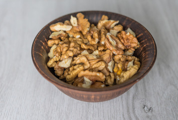 Healthy food  for background image close up walnuts.  Nuts  texture on white grey table top view on the cup plate