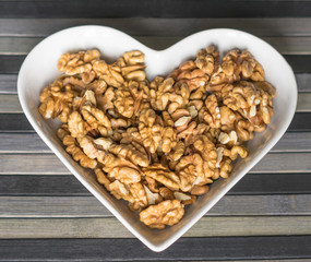 Nuts arranged in heart  on background. Healthy Food image close up walnuts nuts. Love Texture