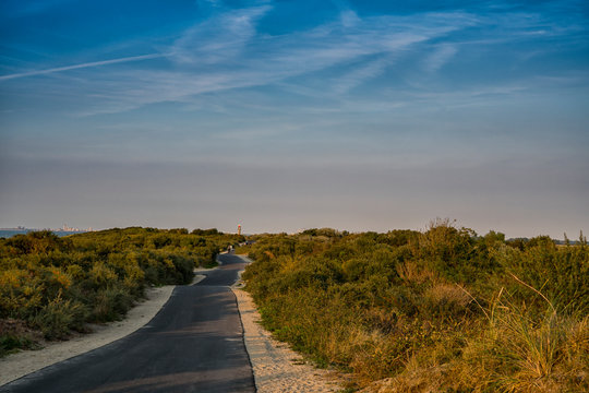 asphalt hiking path through the dunes, to the lighthouse of Cadzand Bad, The Netherlands