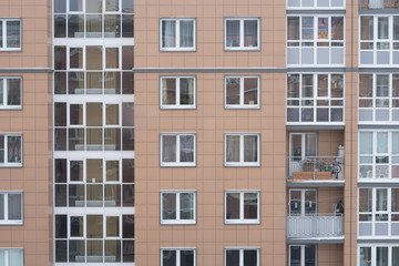 Fototapeta premium multi-storey office building with worker working overtime. lighting and working people within.