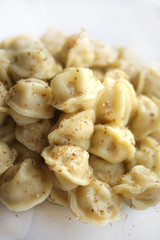 Boiled dumplings and spices. Ready meal on a plate on a white background.