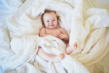 Fototapeta na wymiar Cute little girl playing on bed