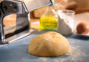 Fresh dough ball and small home dough sheeter on kitchen