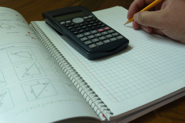 Calculator, notebook and pen.