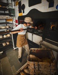 Production of baked bread with a wood oven in a bakery.